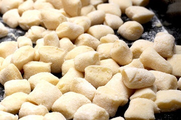 Fototapeta na wymiar gnocchi ready to be cooked. prepared Italian meal. meal preparation details. gnocchi texture.