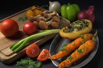 Baked carrots and baked potatoes stuffed with mushrooms decorated with fresh vegetables and mashrooms