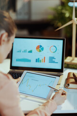 woman using digital tablet analysing investment marketing data