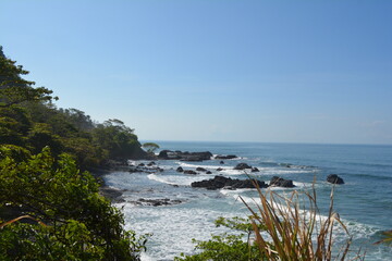 Small hidden beach with waves breaking in the stones