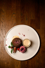 top view on plate with chocolate cake with ice and jar of cream