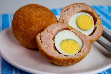 Traditional street food in UK, stuffed fried Scotch eggs with breadcrumbs