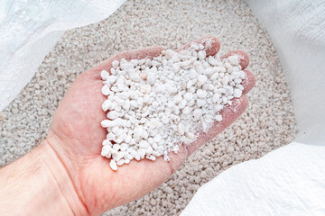 Perlite for plants in the hand. neutral material of volcanic origin