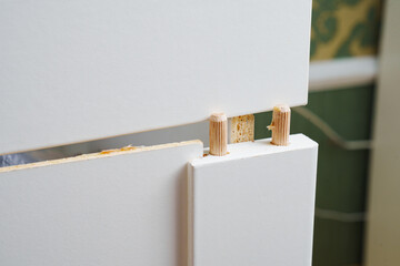 Broken white retractable box of cabinet. furniture repair