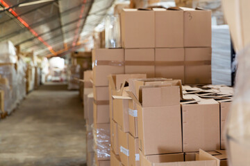 Warehouse - boxes with various goods on racks and on the floor