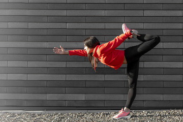 Fitness sport girl in fashion sportswear doing yoga fitness exercise in the street, outdoor sports,...