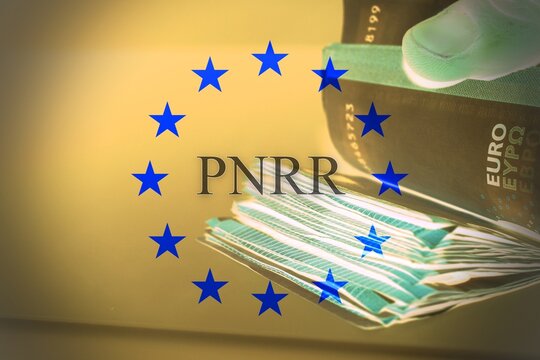 Hand counting european banknotes with the sign "Pnnr" concept of financial help