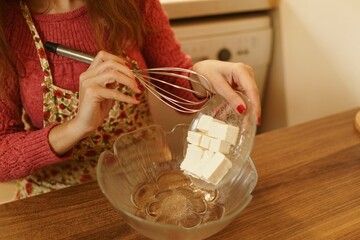 Close-up shot of making cookies. Detail shot of eggs, flour and margarine. Sunset concept, warm tones.