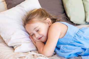 Adorable little child girl sleeping in the bed.