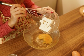 Close-up shot of making cookies. Detail shot of eggs, flour and margarine. Sunset concept, warm tones.