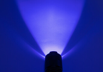 Light from an ultraviolet LED lamp. UV LED flashlight. Ray with a wavelength of UV-365 nm