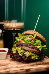 close-up of double hamburger with fresh lettuce and spinach