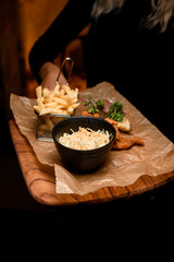 view of french fries and bowl of sauerkraut and delicious batter fried pork ears