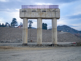 Bridge construction. Bridge supports in the mountains. Interchange construction.