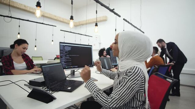 Multiculture software engineers working on start up project and programming in company office