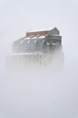 Image of the Ancient/ Abbey of San Michele built on Mount Pirchiriano located at the entrance of the Susa Valley, around the years between 983 and 987 A.D. in the cloud