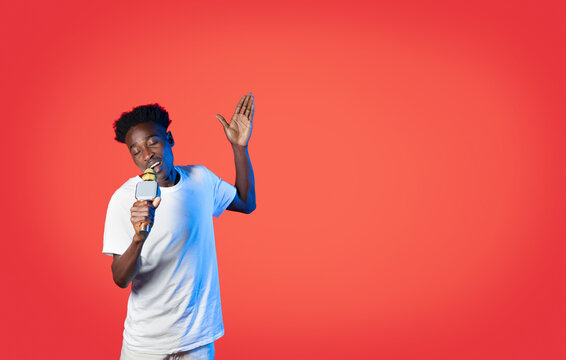 Handsome Black Guy Singing With Closed Eyes, Using Microphone