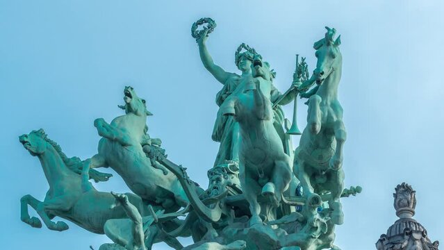 Statue atop the Grand Palais on the Champs Elysee timelapse. Paris, France. Close up view with blue sky at sunny day
