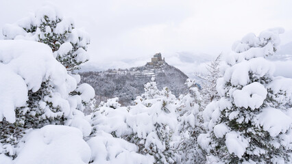 Image of the Ancient/ Abbey of San Michele built on Mount Pirchiriano located at the entrance of the Susa Valley, around the years between 983 and 987 A.D. with an abundant snowfall