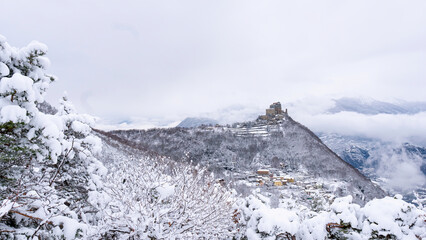 Image of the Ancient/ Abbey of San Michele built on Mount Pirchiriano located at the entrance of the Susa Valley, around the years between 983 and 987 A.D. with an abundant snowfall