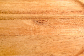 Fototapeta premium Wooden cutting board as background, closeup