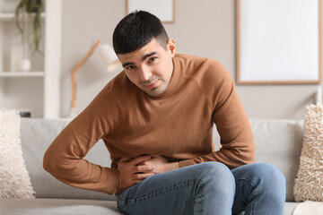 Young man with appendicitis at home