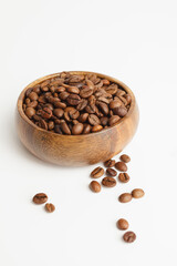 Coffee beans in wooden bowl isolated on white background