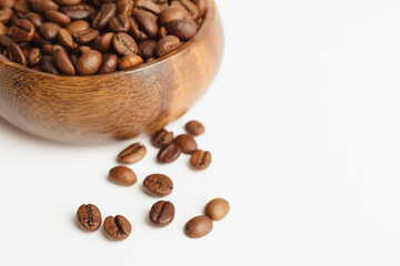 Coffee beans in wooden bowl isolated on white background