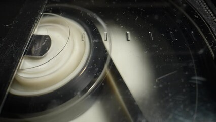 Old VHS cassette in a VCR. Dolly shot. Close-up timelapse