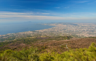 Fototapeta premium Panoramic view from volcano Mount Vesuvius on the bay of Naples, Province of Naples, Campania region, Italy, Europe. Looking at the island of Capri and Mediterranean coastline on a cloudy day.