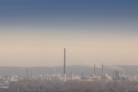 Selective blur on a industry complex, a factory with high chimneys and smokes and fumes in Leverkusen, near Cologne, Germany, polluting the atmosphere and the local environment.