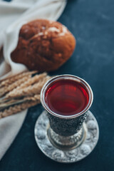 Bread, wine and ears of wheat on a dark background, communion concept