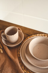 Stylish set of beige dishes on a white background