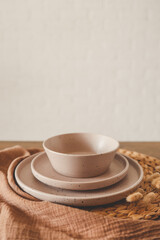 Stylish set of beige dishes on a white background