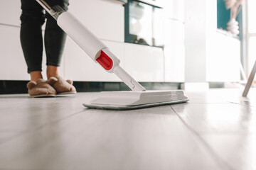 Cleaning Service Woman Mopping The Floor In Kitchen At Home