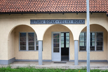 entrance to the train station of Veliki Borak, with the name of the village Veliki borak written in latin and cyrillic alphabet. it's a rural train station in the serbian countryside, in the area of K