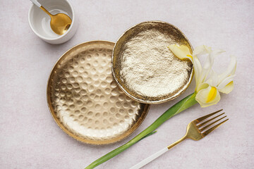 Clean plates, fork and orchid flower on white grunge table