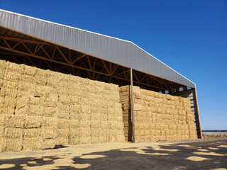 Angled view of a hay barn full of hay bales © Jocelyn
