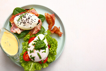Plate with tasty eggs Benedict on white table