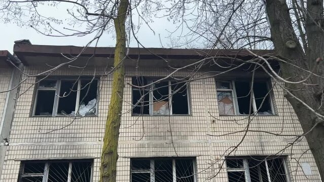 Abandoned two-story building exterior with burnt broken windows