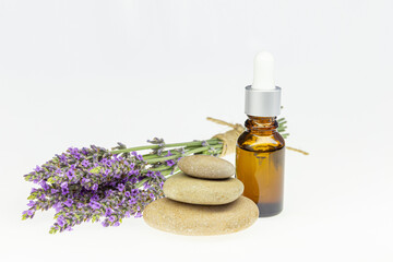 Amber essential lavender oil bottle. Pipette with drop and bottle on an isolated background.