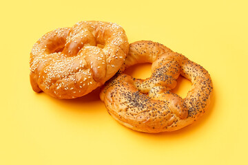 Tasty pretzels on yellow background