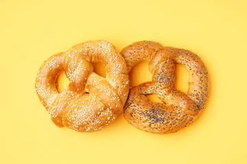 Tasty pretzels on yellow background