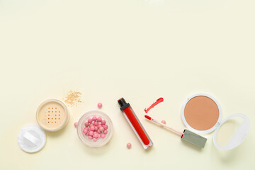 Lipstick with makeup powder on beige background