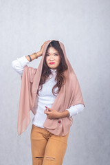 hijab girl dizzy sullen holding one head . portrait Asian Chinese Muslim Muslim hijab headscarf...
