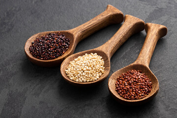 White, red and brown quinoa seeds in spoon - Chenopodium quinoa