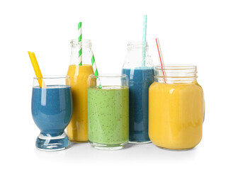 Glasses and bottles of different tasty smoothie with straws on white background