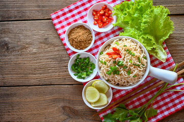 noodles bowl with vegetable spring onion lemon lime lettuce celery and chili on table food , instant noodles cooking tasty eating with bowl - noodle soup