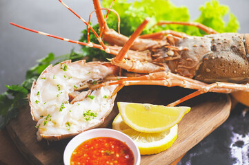 spiny lobster food on plate, fresh lobster or rock lobster seafood with herb and spices lemon...
