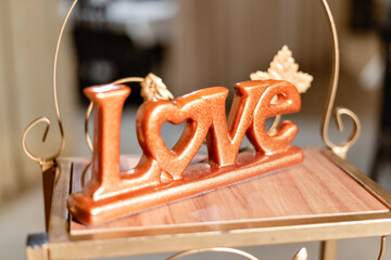 a porcelain plaque with the word love written on it